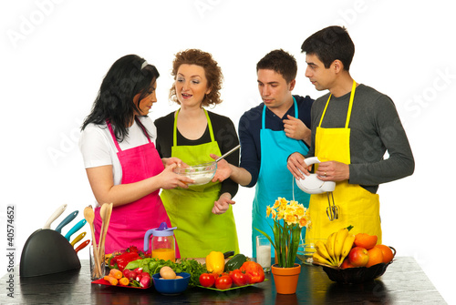 Photo: Happy friends baking together Happy friends baking together