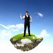 Young businessman standing with his hand up Young businessman standing with his hand up