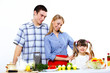 family with a daughter cooking together at home