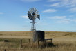 Windmill and water tank on the field in Australia