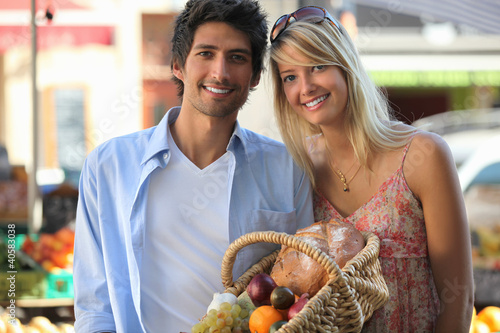 Photo: Couple shopping at the local market Couple shopping at the local market