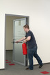 man running with a fire extinguisher