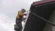 Painting roof of a private house, close-up