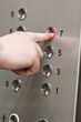 Photo: man pushing buttons on an elevator man pushing buttons on an elevator