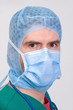 young doctor with bonnet and surgical mask young doctor with bonnet and surgical mask