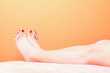 woman feet with red toenails on towel
