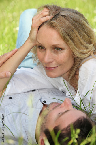 Photo: Couple lying on grass Couple lying on grass