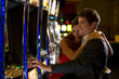 Photo: Young couple playing with slot machines Young couple playing with slot machines