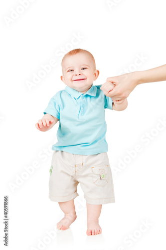 Photo: smiling child walking hand in hand with mom smiling child walking hand in hand with mom
