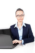 Businesswoman sitting with laptop in office