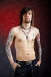 Brutal thoughtful man with tattoo