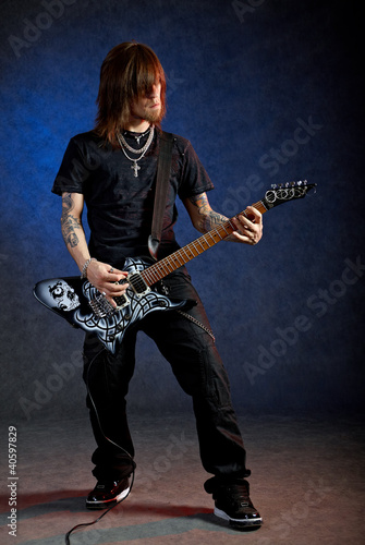 Photo: Brutal man playing electric guitar Brutal man playing electric guitar