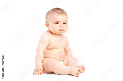 Photo: A 9 month old baby in diapers sitting A 9 month old baby in diapers sitting