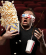 Very scared man watching 3D movie