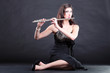 girl and flute on a black background