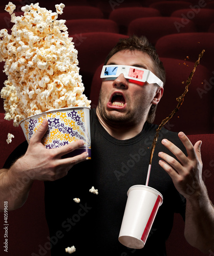 Photo: Very scared man watching 3D movie Very scared man watching 3D movie