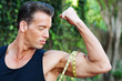 Photo: Muscular man measuring bicep Muscular man measuring bicep