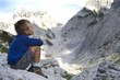 Little boy admiring mountain landscape