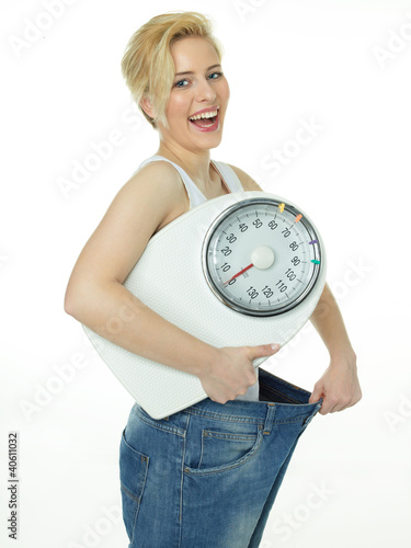 Foto: Beautiful girl with scale is proud to lose weight Beautiful girl with scale is proud to lose weight