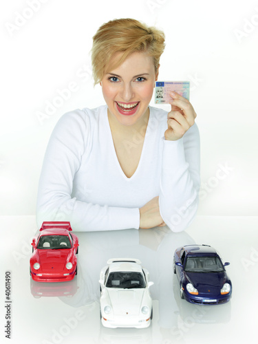 Photo: Woman shows her driver licence and her dream cars Woman shows her driver licence and her dream cars