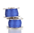 Metal spools of thread isolated on white
