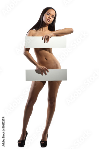 Photo: Very beautiful nude model is holding a board in her hands on whi Very beautiful nude model is holding a board in her hands on whi