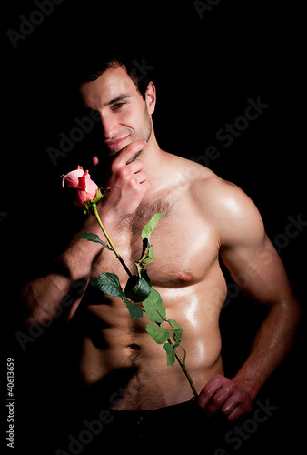 Photo: Valentines man in a fashion pose with rose Valentines man in a fashion pose with rose