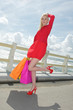 Young blonde shopping woman with bags,sea background. Young blonde shopping woman with bags,sea background.