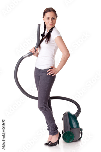 Photo: .Young woman with vacuum cleaner. .Young woman with vacuum cleaner.