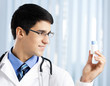 Happy doctor showing bottle of drugs
