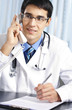 Young doctor on phone, at office