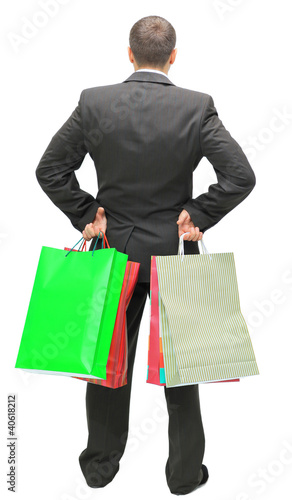 Photo: Happy shopping man. Isolated over white background Happy shopping man. Isolated over white background