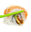 Green sticks keep roll with salmon, isolated on white background