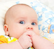 Infant with hands in mouth