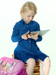Cute little pupil plays concentrated with tabletpc