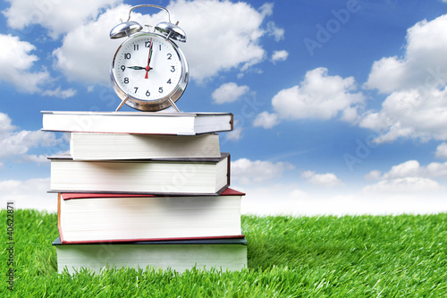 Photo: Alarm clock and stack of books Alarm clock and stack of books