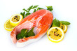 Red fish with lemon, parsley and pepper isolated on white.
