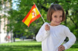 A Young Girl Holding Spanish Flag A Young Girl Holding Spanish Flag