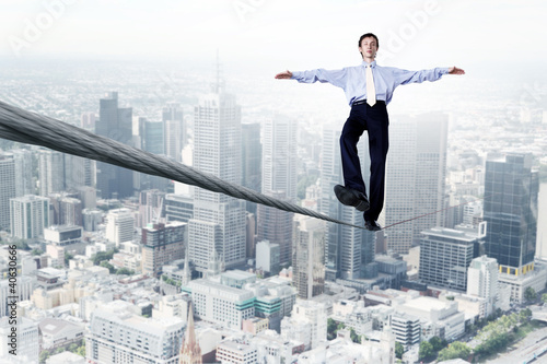 Photo: Business man balancing on the rope Business man balancing on the rope