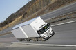 giant white truck driving on freeway giant white truck driving on freeway