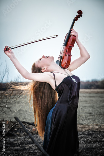 Photo: The red-haired girl with a violin outdoor The red-haired girl with a violin outdoor