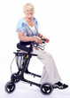 Photo: happy elderly lady sitting on a walker for disabled people happy elderly lady sitting on a walker for disabled people
