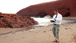 Video: Angry businessman chatting on tablet on beautiful Legzira beach Angry businessman chatting on tablet on beautiful Legzira beach