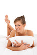 Woman lying on bed isolated on white background