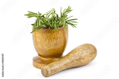 Photo: fresh green rosemary in mortar isolated on white fresh green rosemary in mortar isolated on white