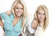 two beautiful woman taking photo a smart phone