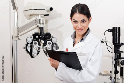 Photo: Smiling Young Optometrist With Clipboard Smiling Young Optometrist With Clipboard