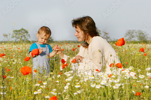 Photo: mother and child playing on natural background mother and child playing on natural background