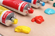 Five paint tubes over a pallete