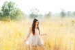 Asian indian woman walking in golden dried field Asian indian woman walking in golden dried field